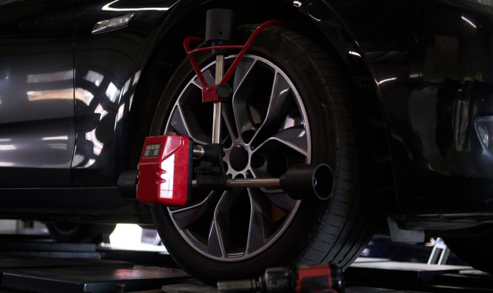 Closeup photoshoot of process or tyre balancing at dark auto service.