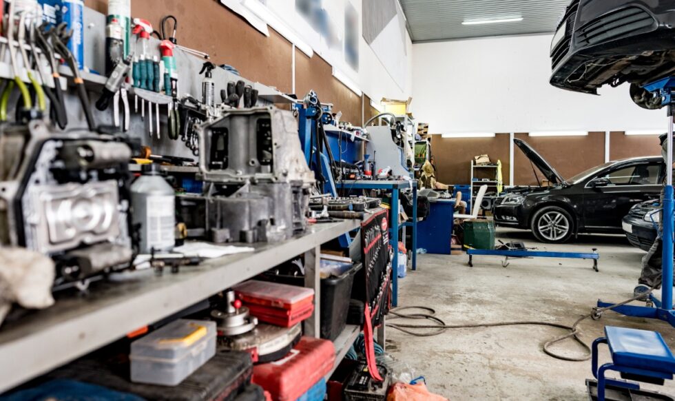 Large workbench with tools at station for vehicle technical servicing Large workbench with tools at station for vehicle technical servicing close up